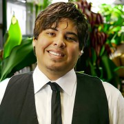 Smiling young man with shaggy dark hair